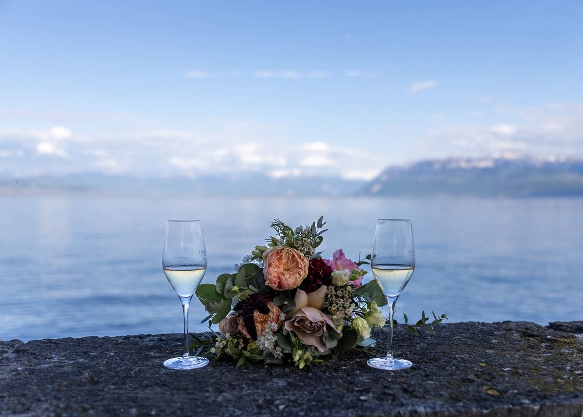 Mariage — séquence émotion, deux verres et bouquet au bord du lac